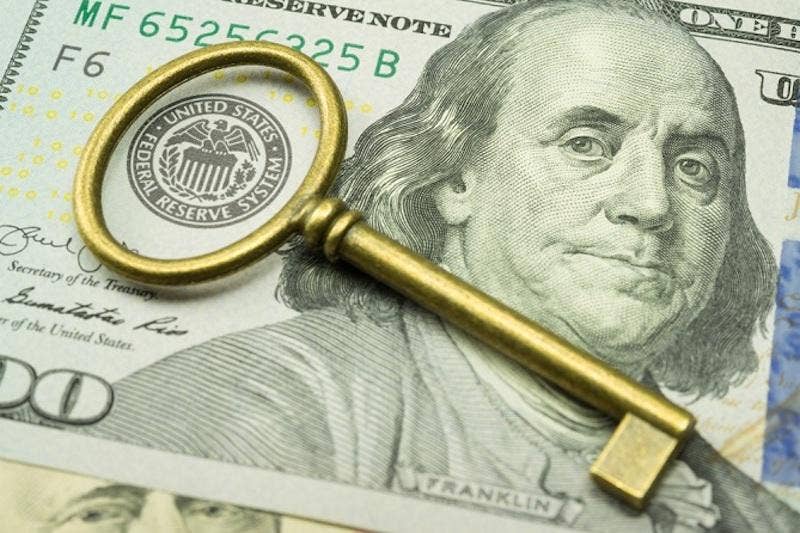 Gold key placed on top of US Dollar
